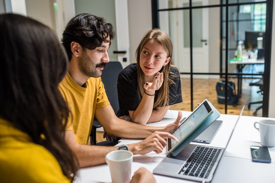 People in the office discussing things.